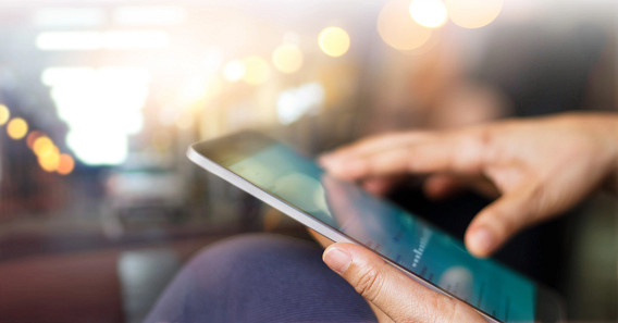 Hands holding a tablet